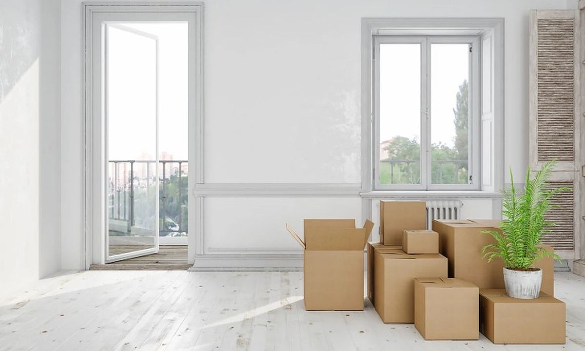Vaciar un piso de alquiler: quién paga Salón de un piso de alquiler con las cajas del inquilino preparadas para la salida